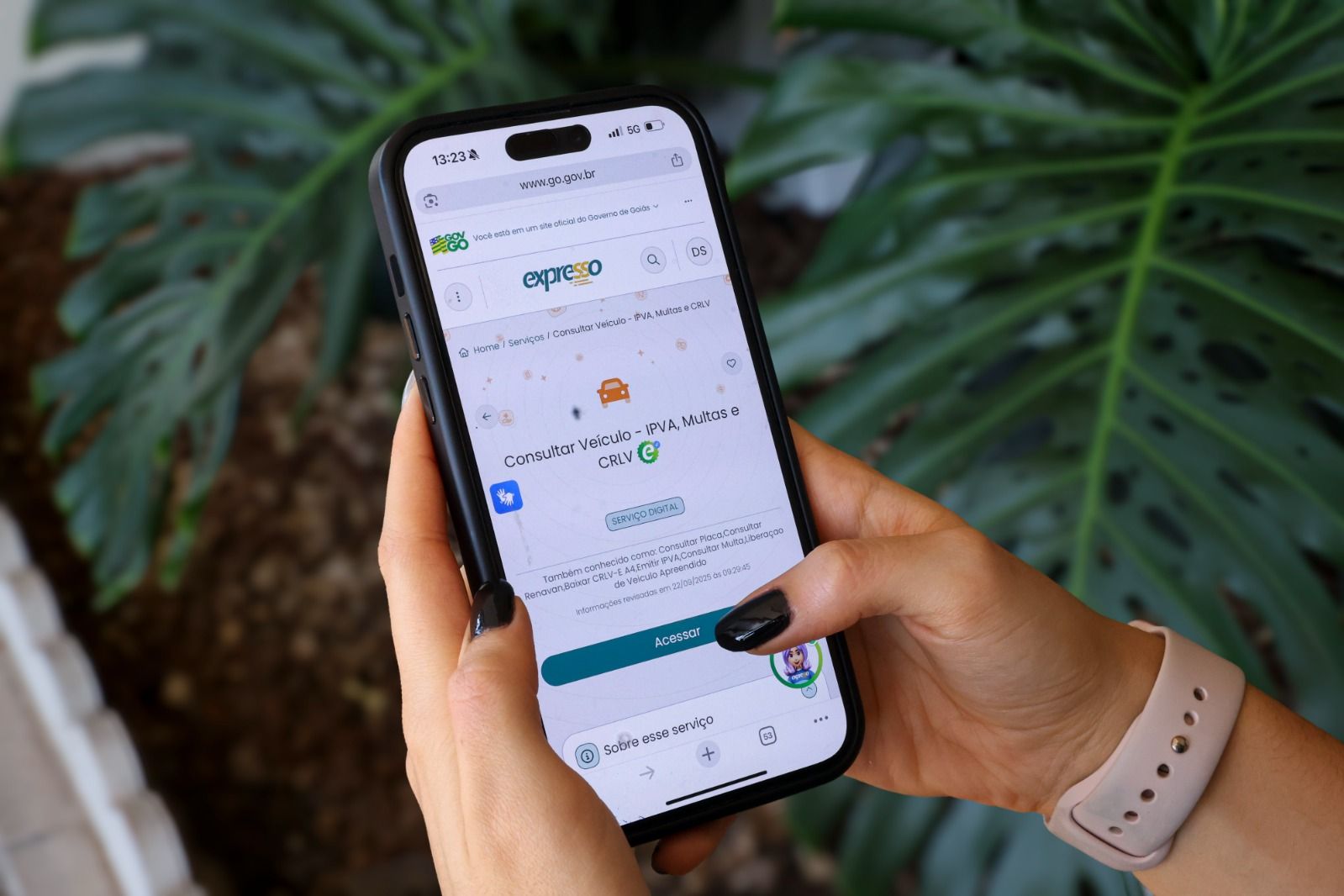 Mão segura celular com tela de aplicativo de pagamento aberta